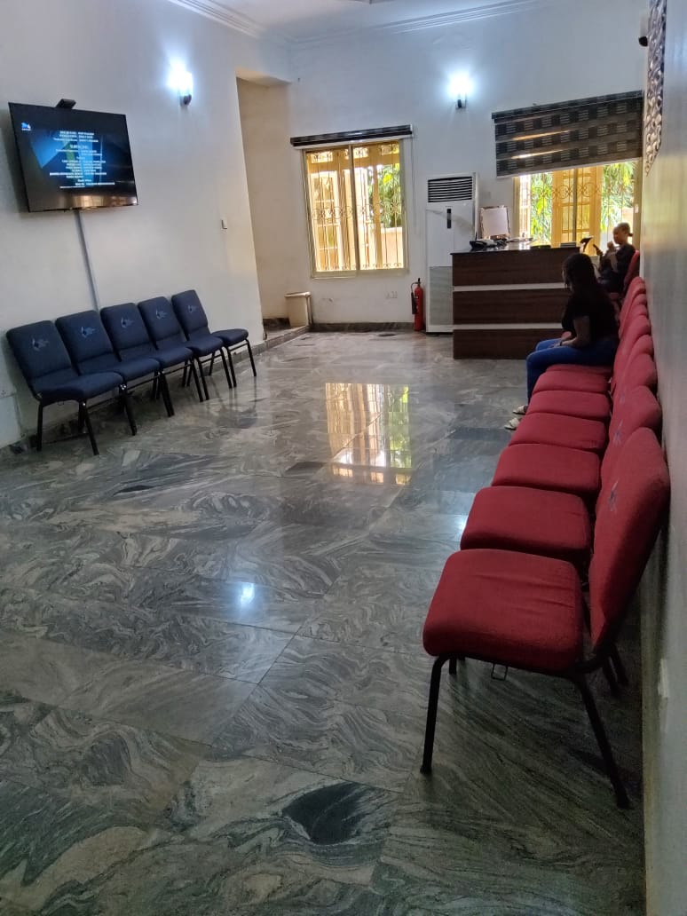 Patient waiting hall with seating and TV