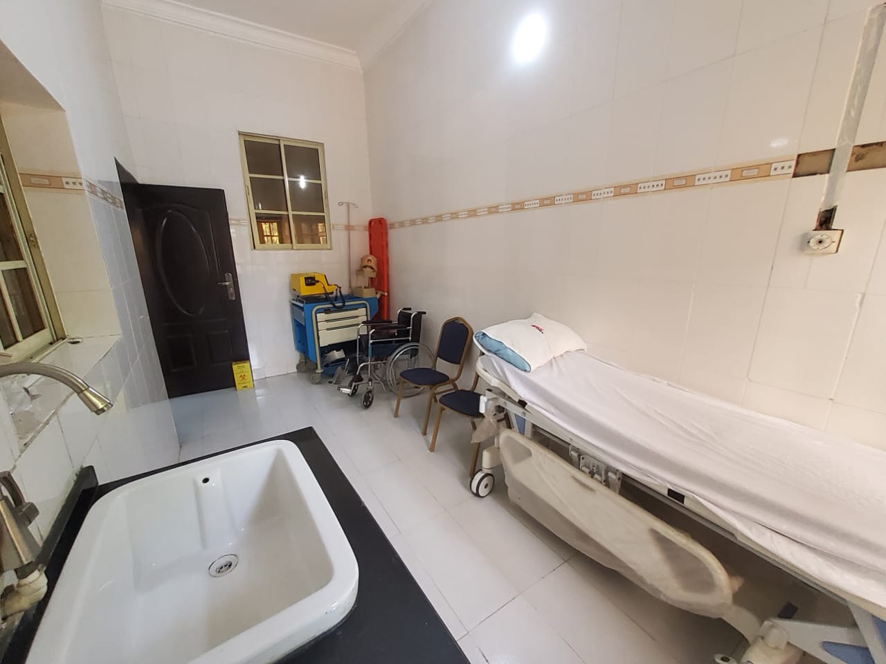 Modern patient treatment room with hospital bed and equipment